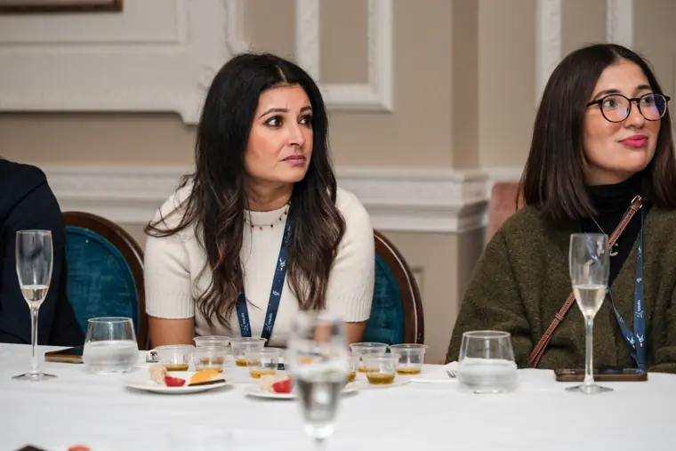 Attendees following the discussion at the table.