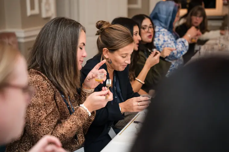Guests examining tasting notes and samples.