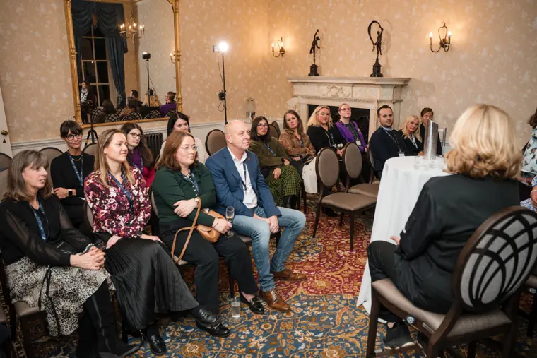 Guests listening to the panel conversation.