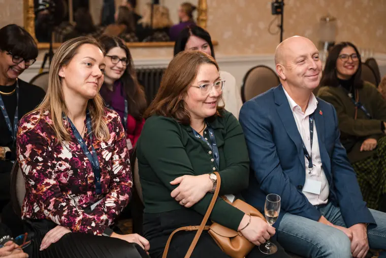 Audience members smiling during the conversation.