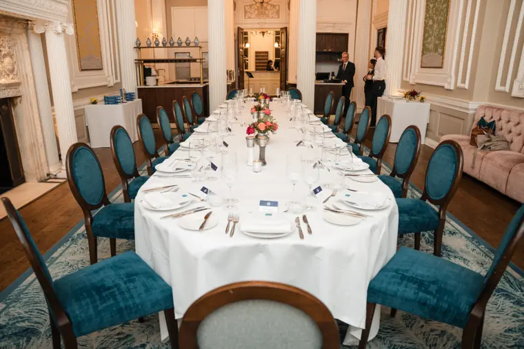 Long table set for the evening meal.