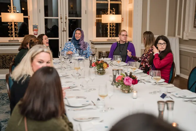 Dinner guests talking across the table.