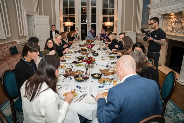 Wide view of guests seated for dinner.