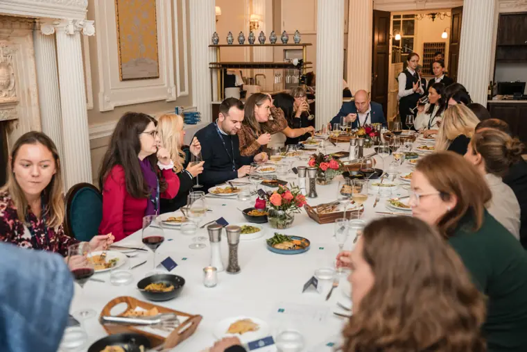 Attendees enjoying dinner together.