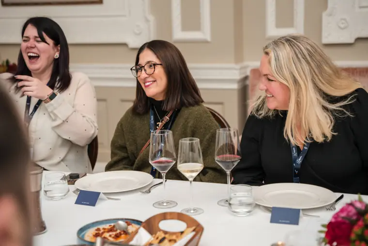 Attendees sharing a laugh during the meal.