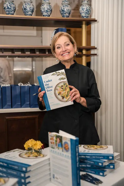 Host holding a recipe book for attendees.