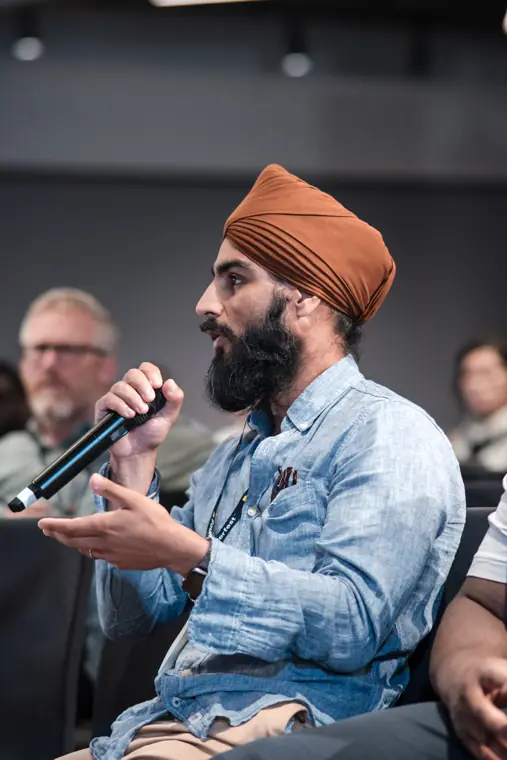 Audience member contributing to a discussion.