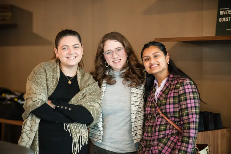 Three attendees pose together at the Ascend showcase.