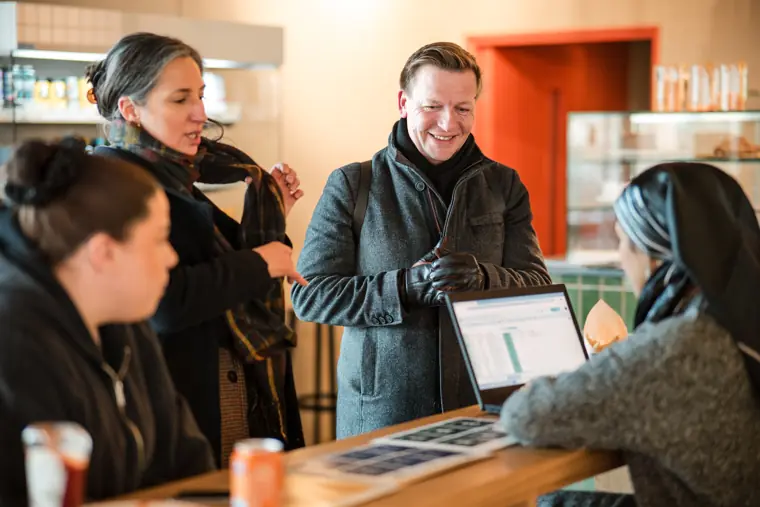 A guest checks information at the welcome desk.