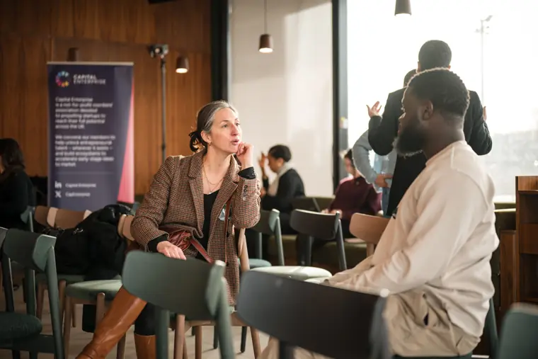 A founder meets another attendee during the reception.