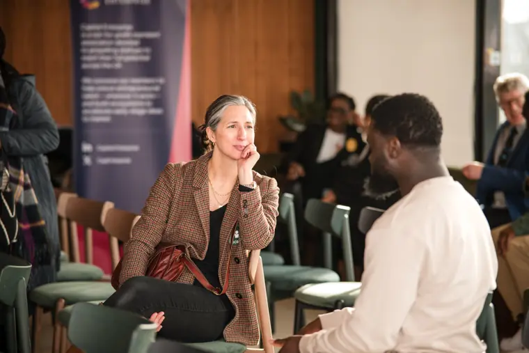 A founder speaks with a guest during the break.