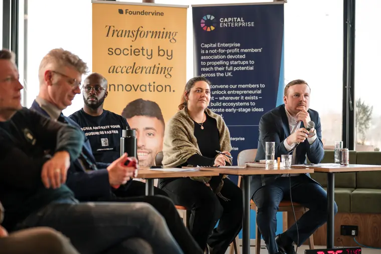 The judging panel listens to a speaker.