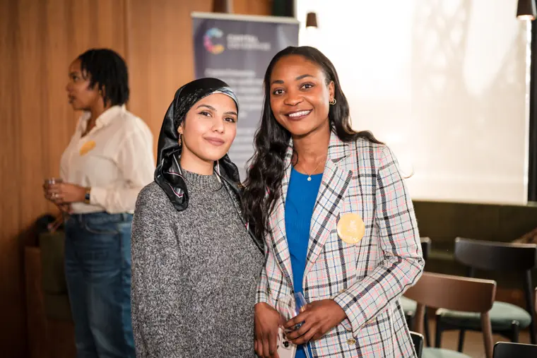 Two participants pose together after the talks.