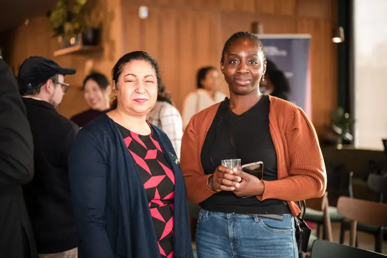 Two women pose together during the showcase.