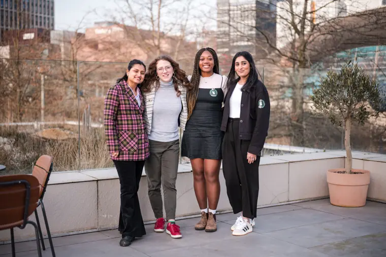 Four founders pose together on the venue terrace.