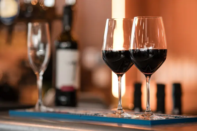 Two glasses of red wine at the reception bar.