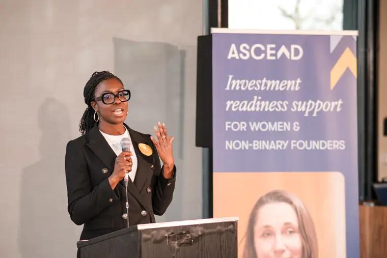 A speaker gestures during her presentation.