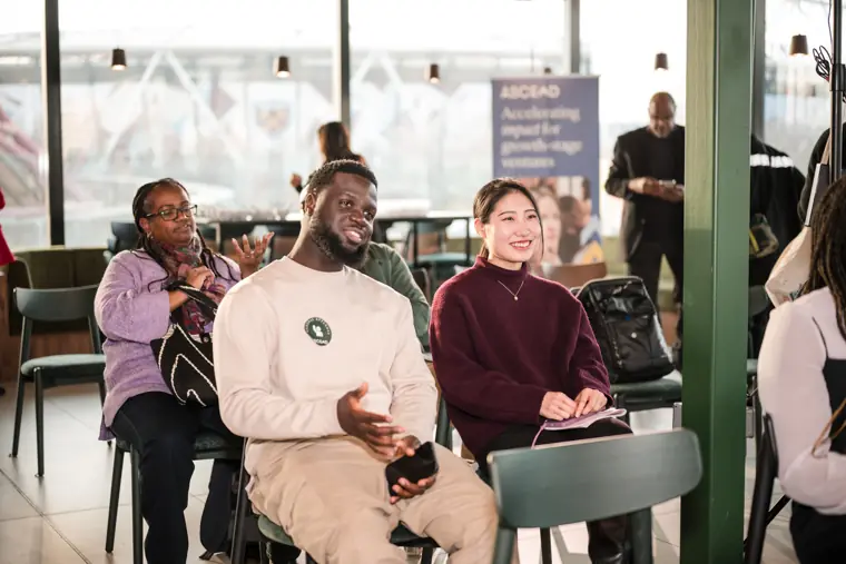 Two attendees react during the programme.