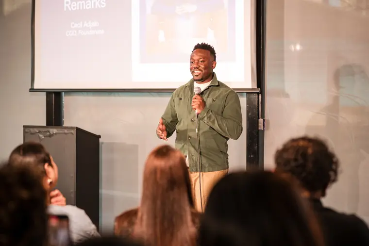 A founder speaks to the audience during the final presentations.