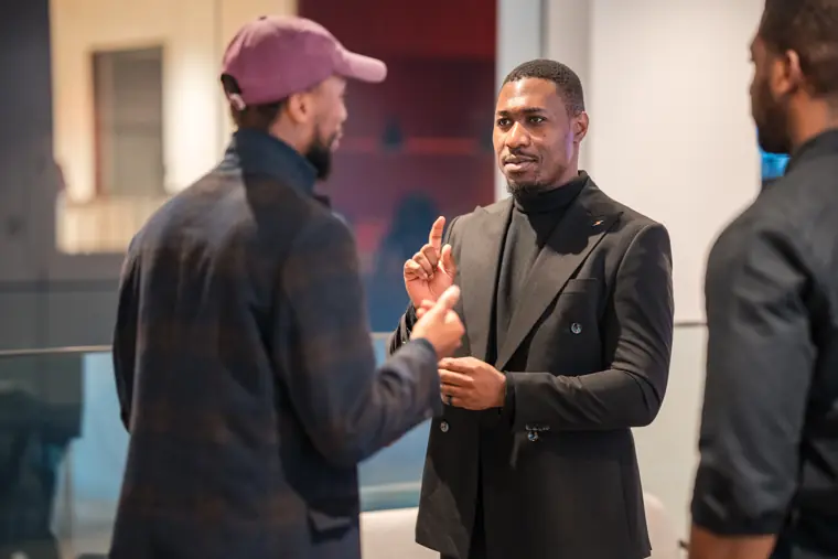 Two guests reconnect at the showcase reception.