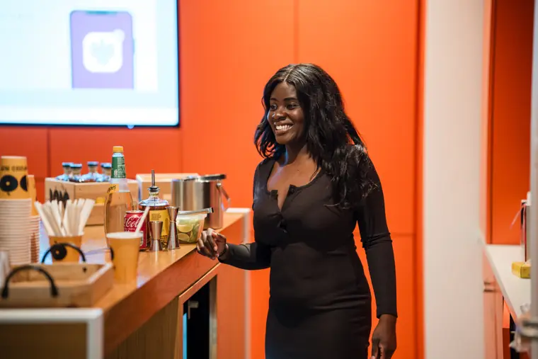 A guest smiles beside the welcome drinks.