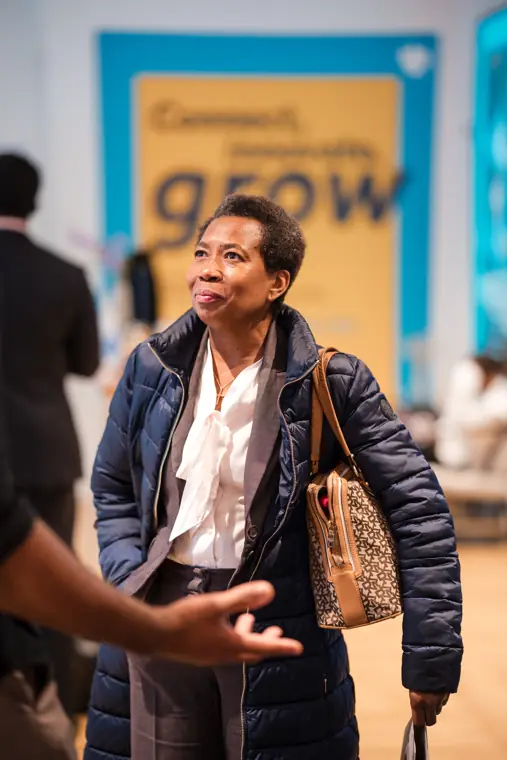 An attendee smiles beneath the Foundervine banner.