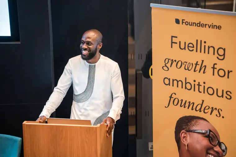A speaker smiles during his welcome remarks.