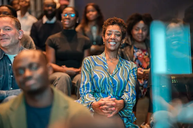 The audience reacts to a moment on stage.