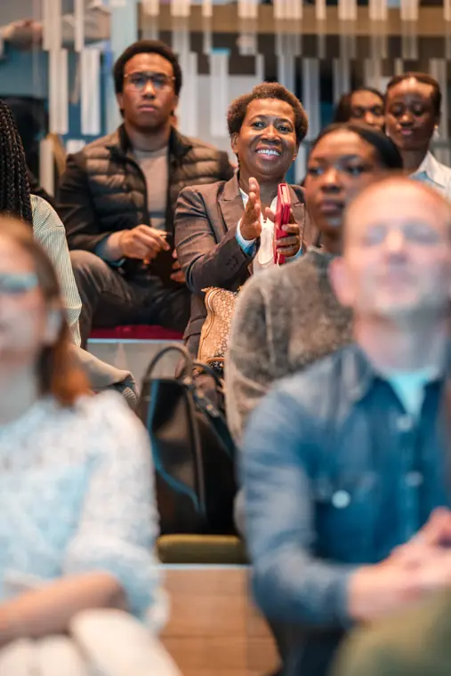 Guests follow the presentation from the front row.