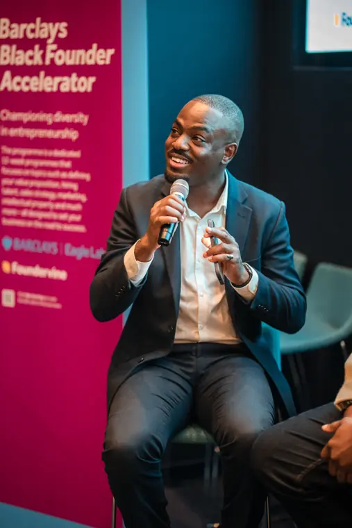A panel speaker talks beside the accelerator banner.