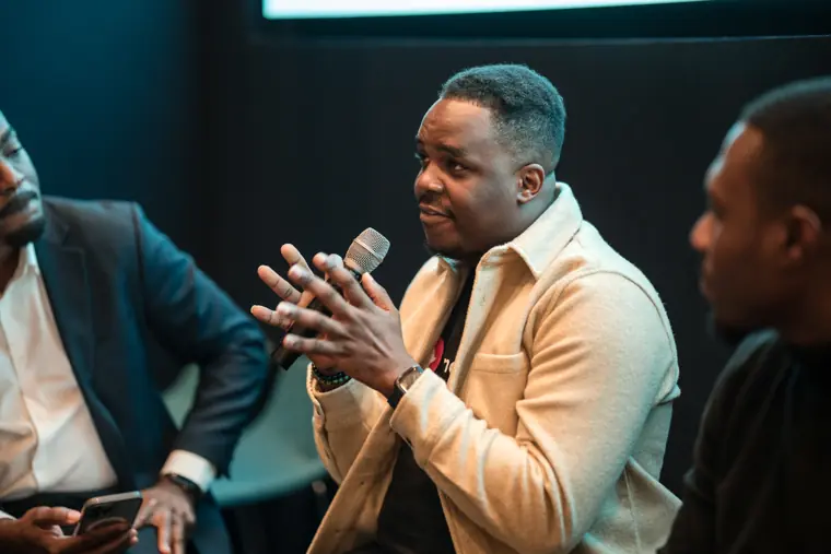 A panelist gestures while answering a question.