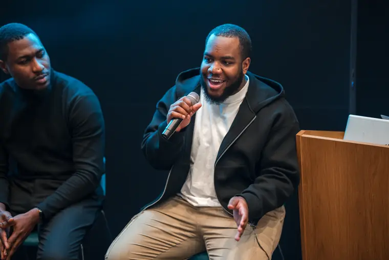 Two panelists share a lighter moment.