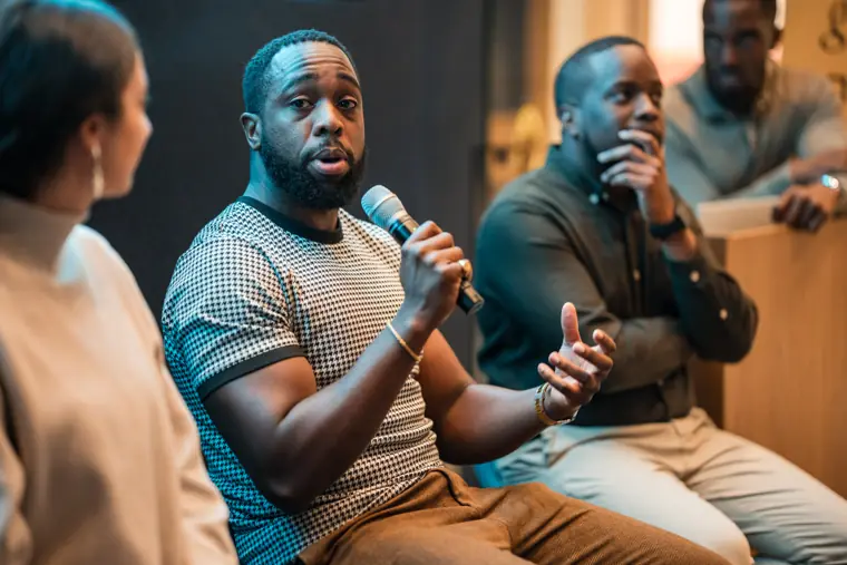 Two panelists share a discussion on stage.