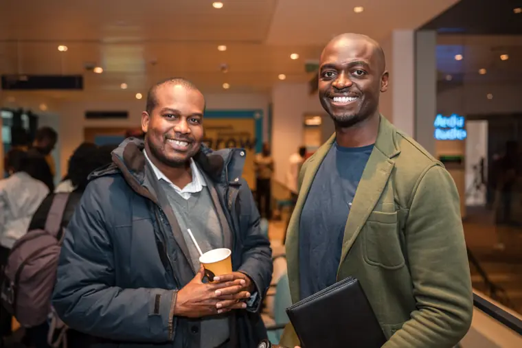Two founders pose for a reception portrait.