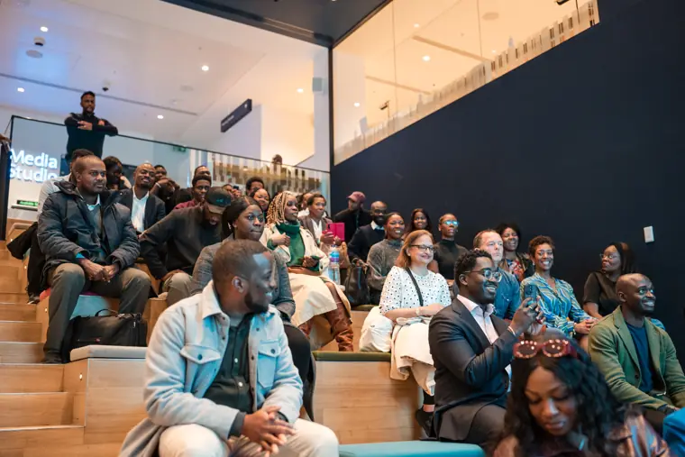 The showcase audience fills the event room.