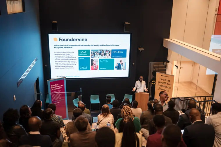 A founder speaks at the lectern.