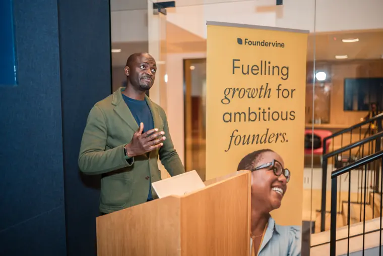 A founder talks from the lectern.