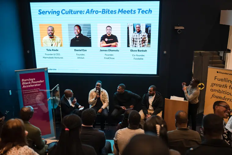 The full panel and audience during the showcase.