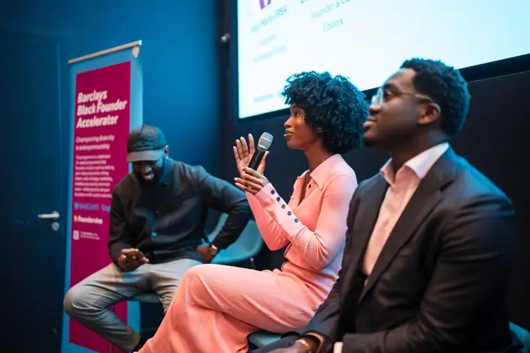 A founder and panelists discuss a question.