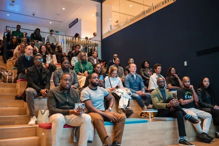 Attendees watch the panel from their seats.