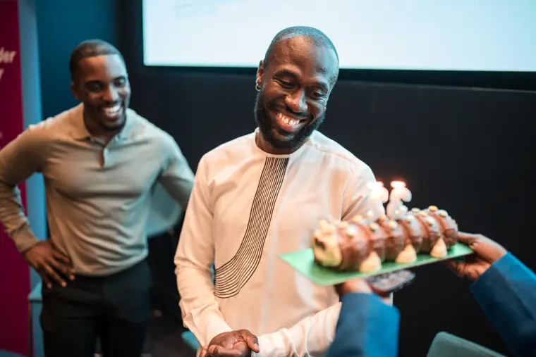 A founder marks the occasion with a cake.