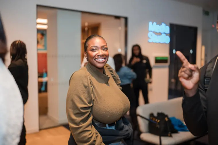 An attendee smiles at the photographer.