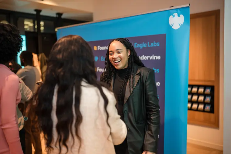 Attendees reconnect near the event branding.