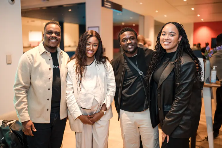 Four guests pose together after the showcase.