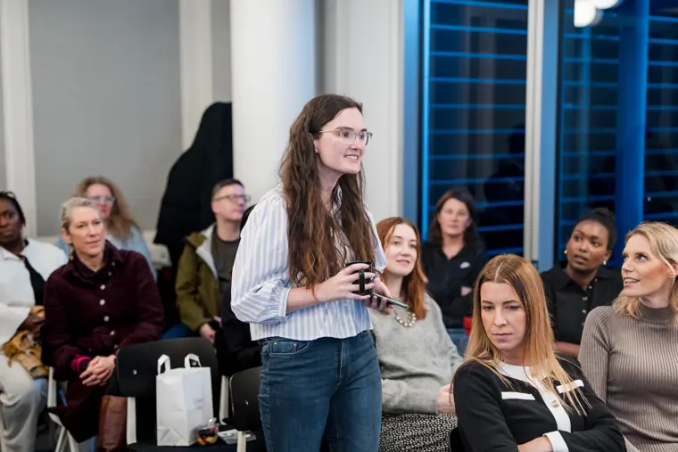 Guests follow a presentation at the launch event.