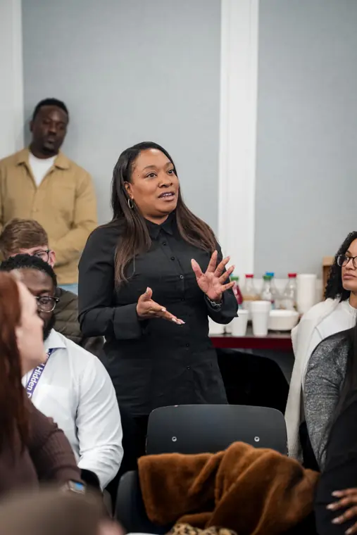 A speaker shares the programme with the room.
