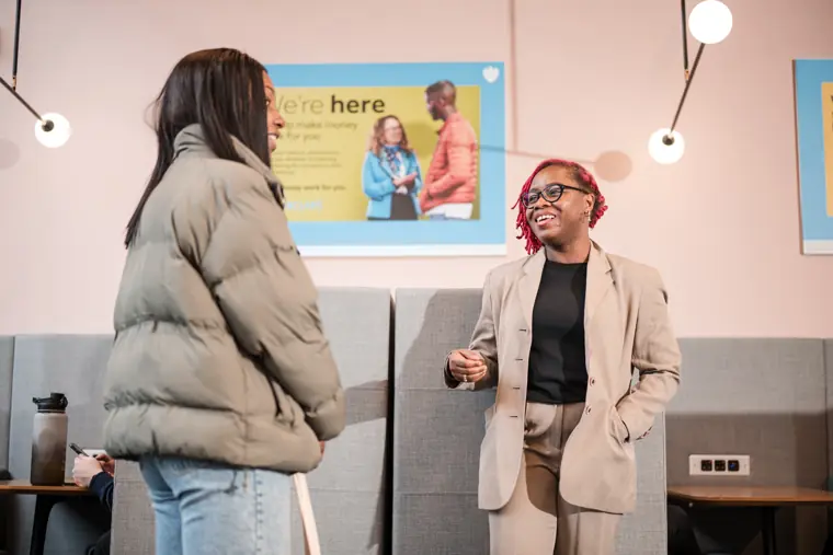 Two attendees discuss a business idea.