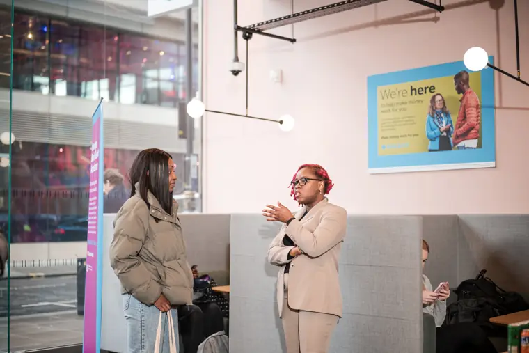 Two guests meet while the programme continues.