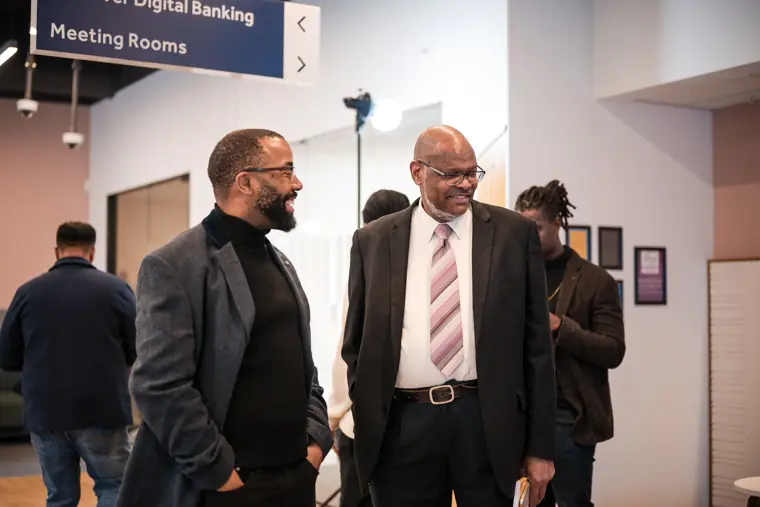 Two attendees meet during the programme.