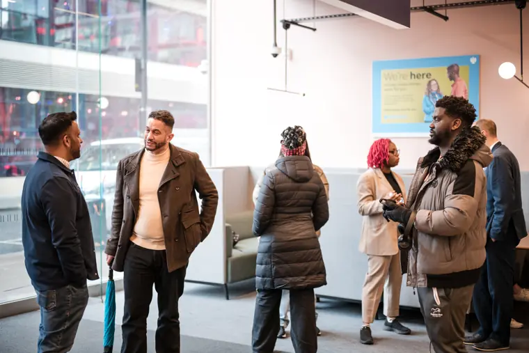 Guests gather near the front of the venue.